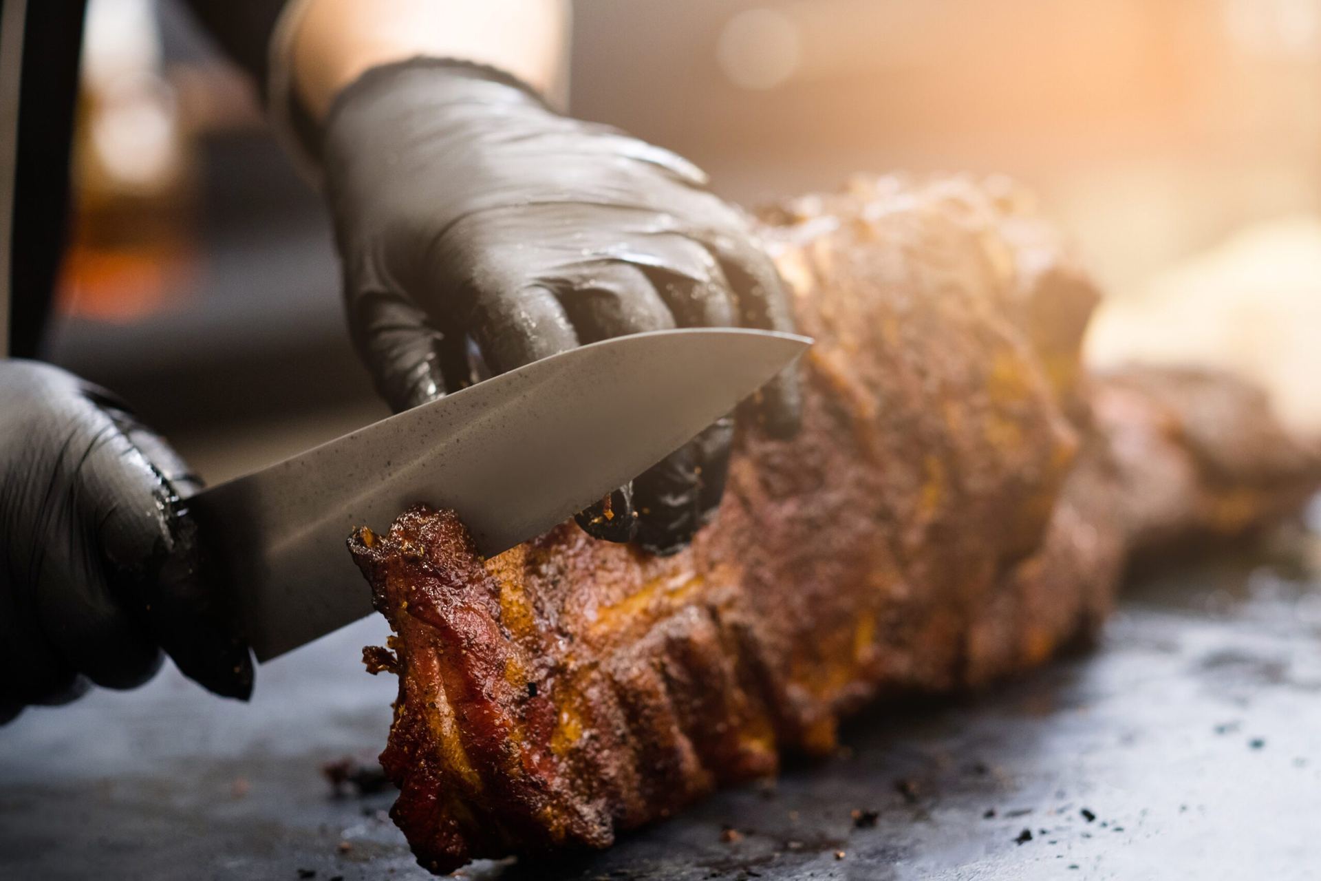 Fajitas being sliced on the grill for a catered event